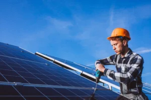 man worker in the firld by the solar panels min 980x653 1